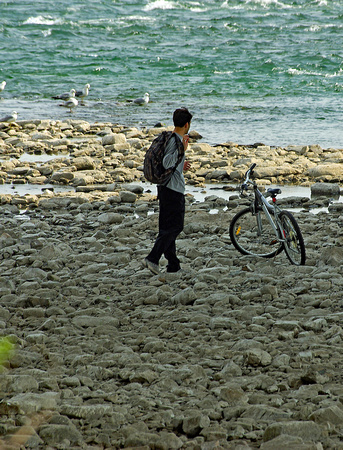 Elaine Bacal_Cyclist on the river rocks